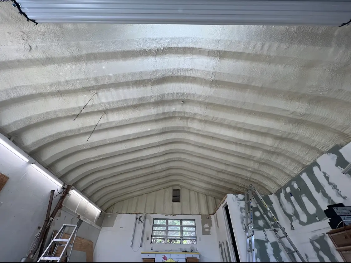 Spray polyurethane foam applied to the underside of a metal roof deck in Charlestown